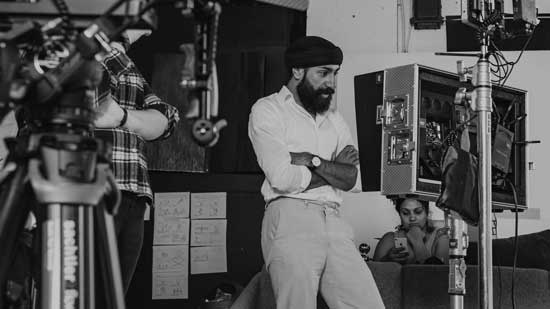 Sandeep directing and looking expectantly at a field monitor